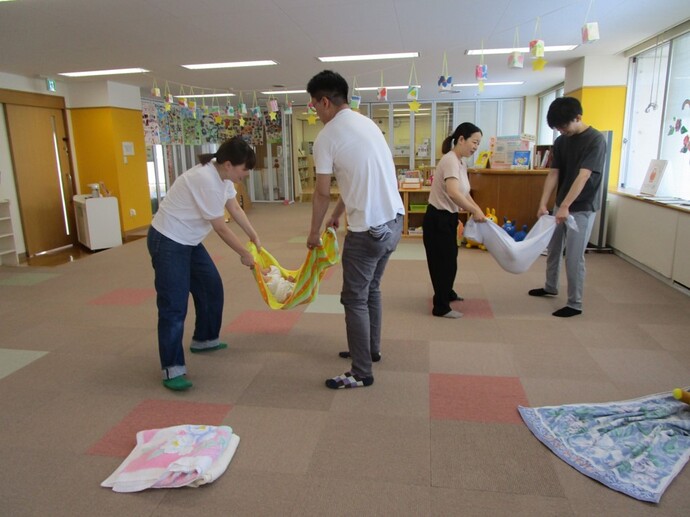 写真:親子でシーツブランコをしている様子