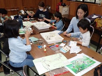 写真:捕まえてきた生きものをスケッチする親子